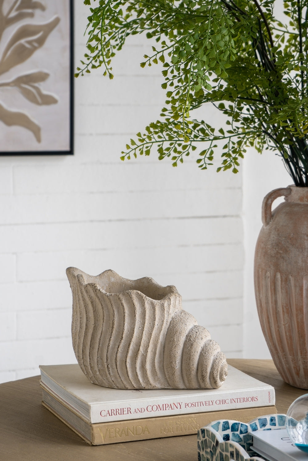 HouseOfZazla Nautilus shell planter, textured beige cement finish, 11.5x7x7 in decor piece atop books on Tampa Home & Garden Store