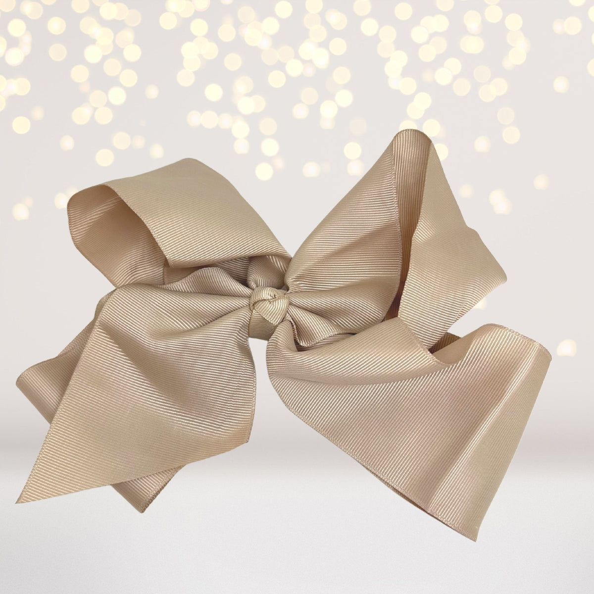 Girls 8-inch-wide beige satin hair bow on an alligator clip on Tampa Home & Garden Store