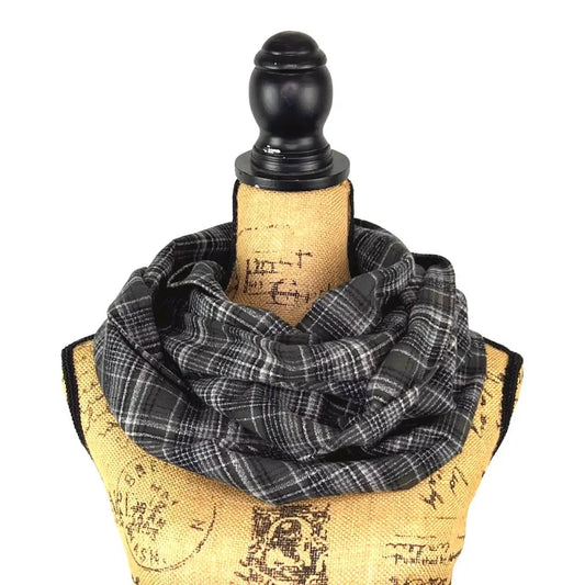 Thistle & Stitch organic cotton plaid infinity scarf in charcoal gray and white draped on a dress form on Tampa Home & Garden Store