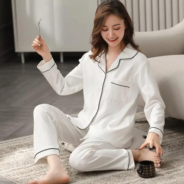 Stevvex white cotton pajama set with black piping, button-down top and pants worn by a woman on Tampa Home & Garden Store