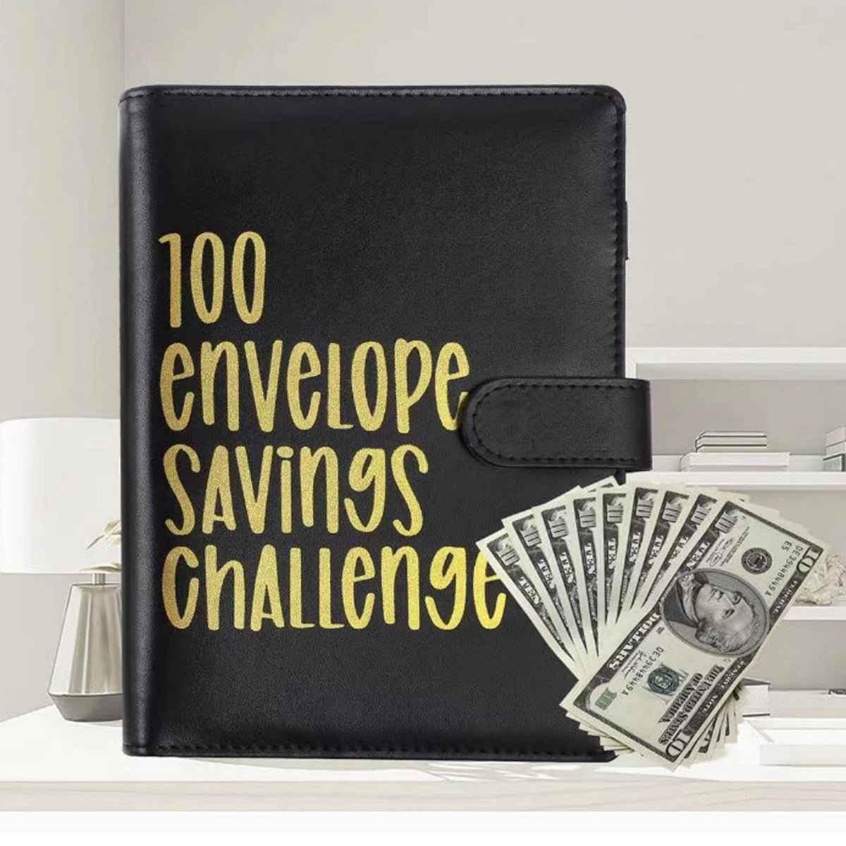 100 Envelope Challenge binder black with gold lettering, cash bills fanned on Tampa Home & Garden Store