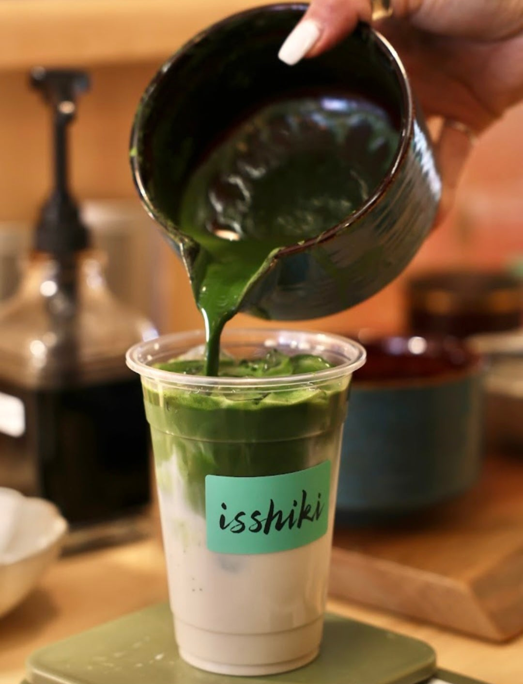 Samidori matcha poured into a clear isshiki cup, green latte with milk layer on Tampa Home & Garden Store