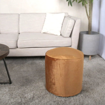 Shimon cylinder pouf ottoman and floor cushion beside a gray sofa on Tampa Home & Garden Store