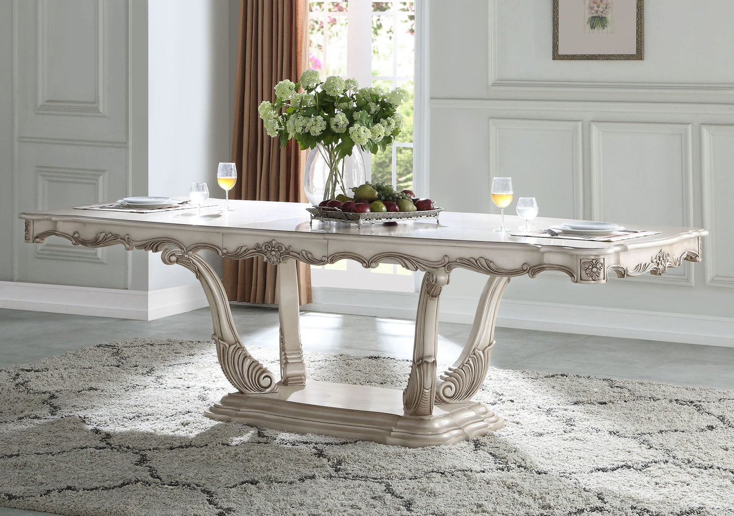 Gorsedd Dining Table Gold finish with ornate carved legs in a bright dining room on Tampa Home & Garden Store