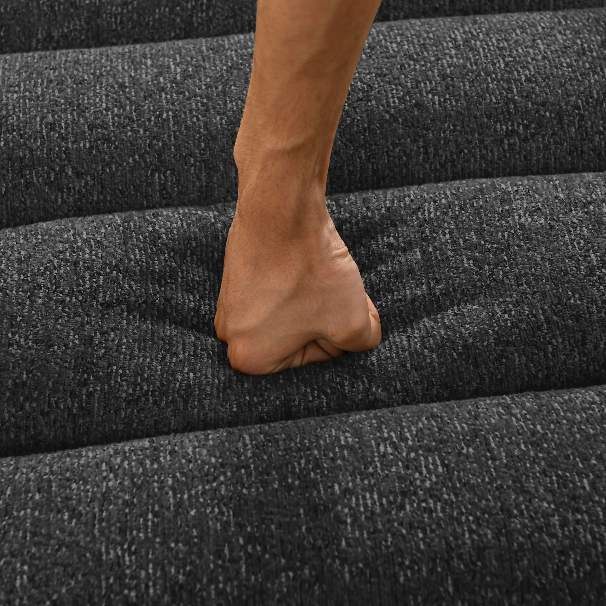 Bare feet on textured dark gray carpet staircase close-up view on Tampa Home & Garden Store