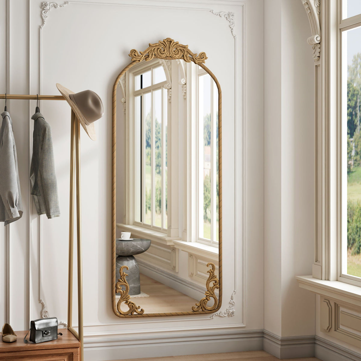Full-body arched wall mirror with gold carved applique on a white paneled wall on Tampa Home & Garden Store