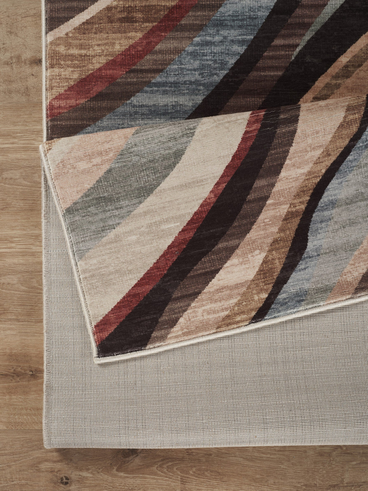 Modern polyester rug by HouseOfZazla with diagonal beige, brown, red and blue stripes on wood floor on Tampa Home & Garden Store