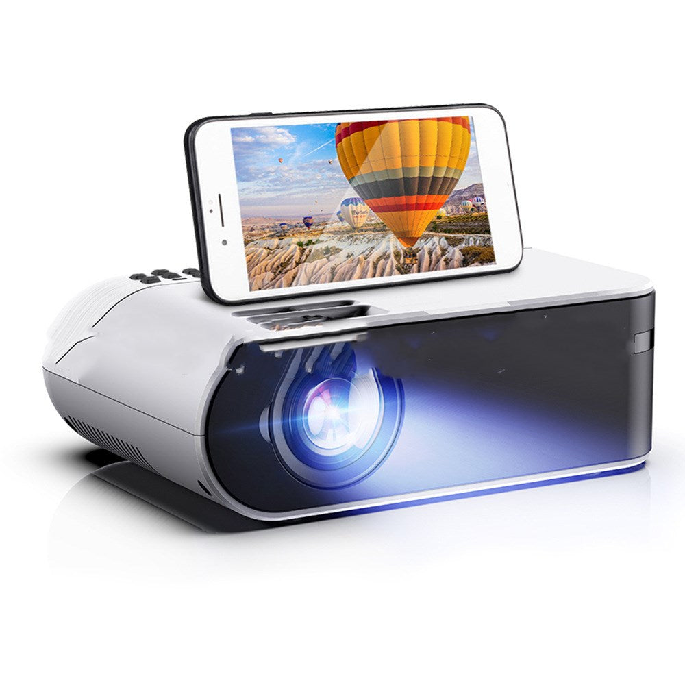 Mini portable projector with smartphone on top, white body and blue glow My Store projector on Tampa Home & Garden Store