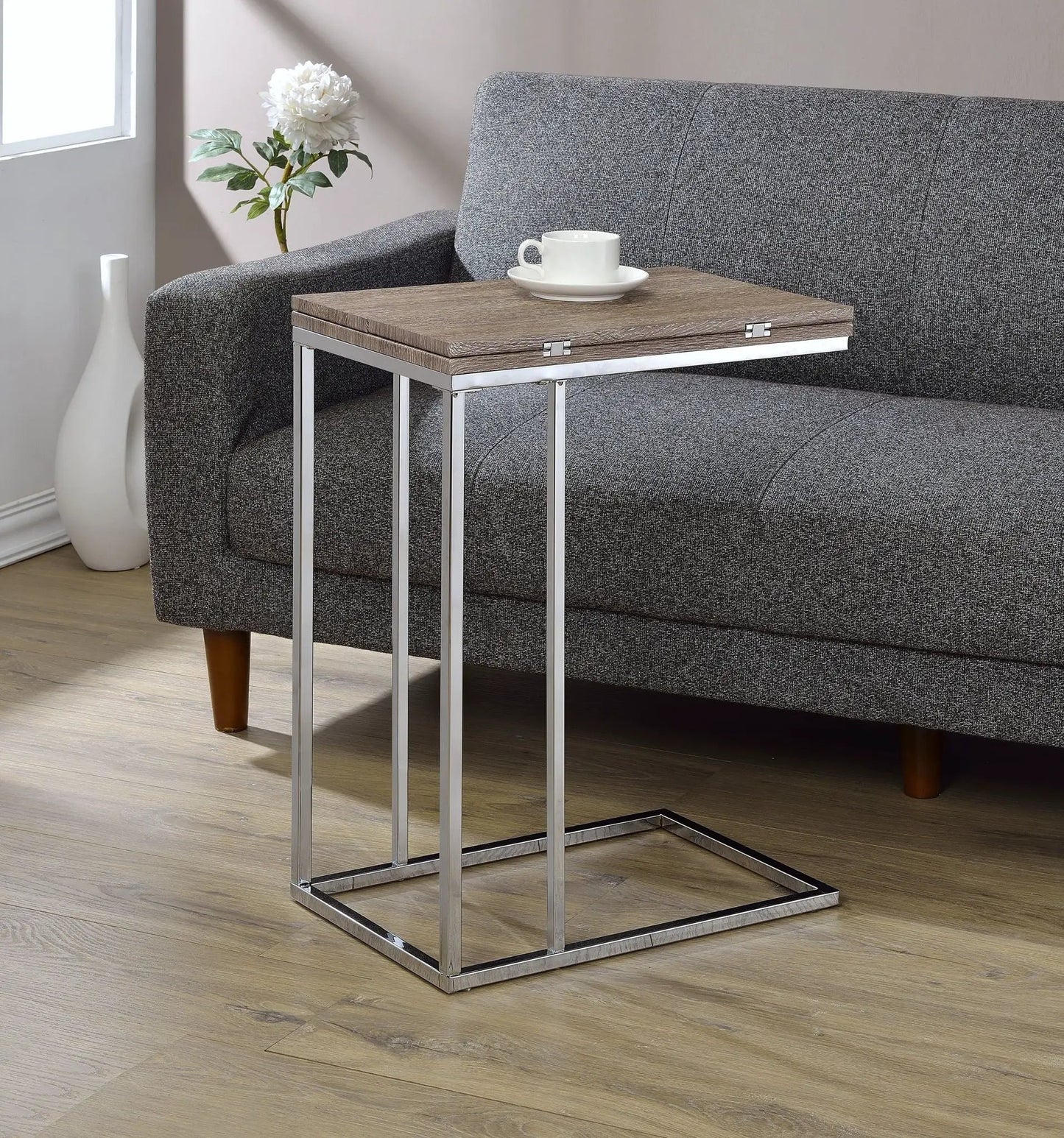 Danson Weathered Oak Accent Table with chrome metal frame beside a grey sofa on Tampa Home & Garden Store