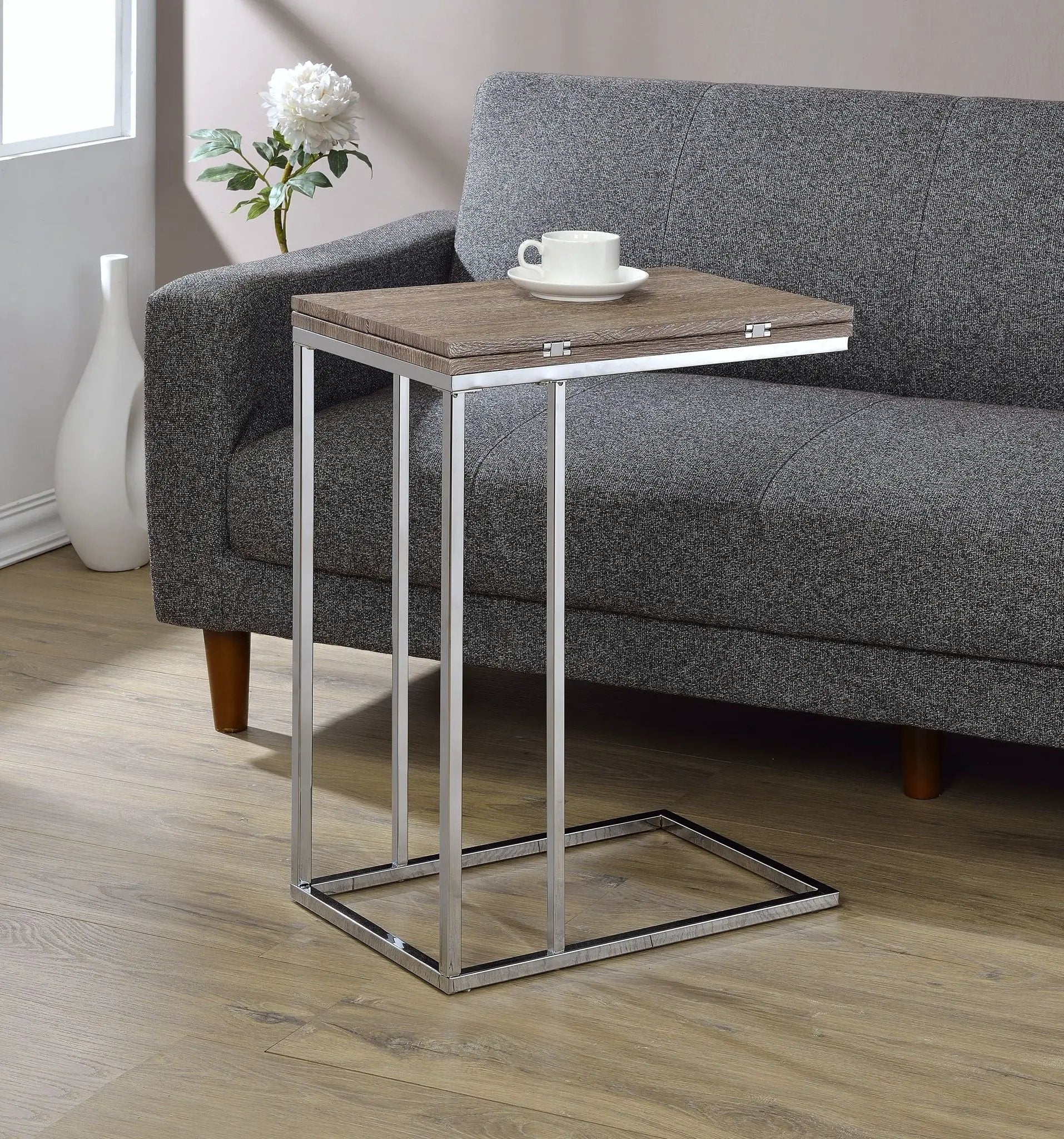 Danson Weathered Oak Accent Table with chrome metal frame beside a grey sofa on Tampa Home & Garden Store