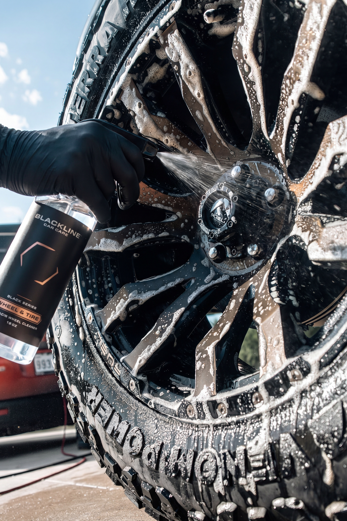 BLACKLINE WHEEL N' TIRE CLEANER sprayed on a black alloy wheel; Blackline Car Care bottle visible on Tampa Home & Garden Store