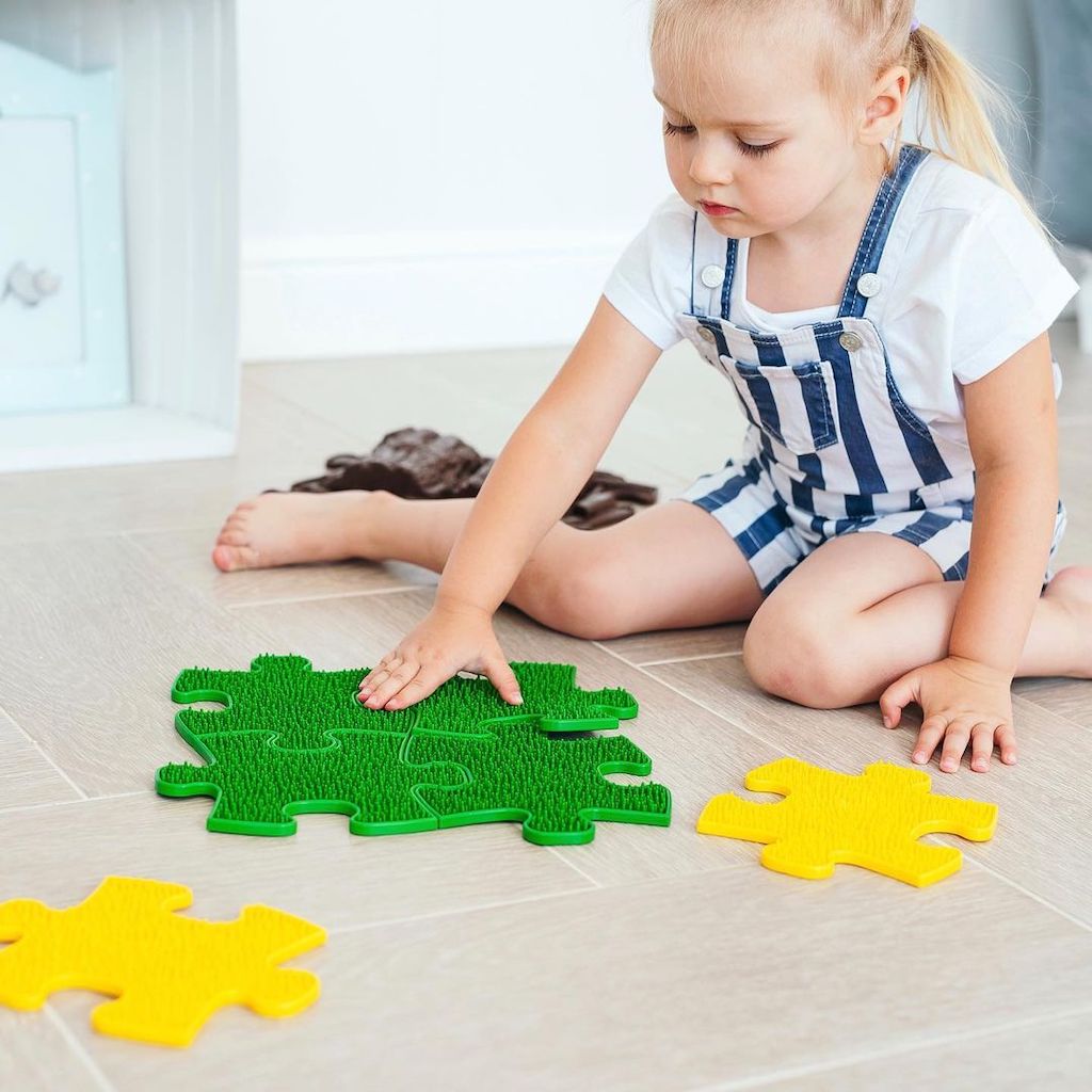 Tots Minis Puzzle Set play mats: green interlocking mat and yellow pieces, toddler on floor on Tampa Home & Garden Store