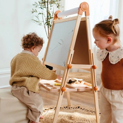 Tiny Land Magnitales Kids Easel in caramel wood with orange joints and paper roll on board on Tampa Home & Garden Store