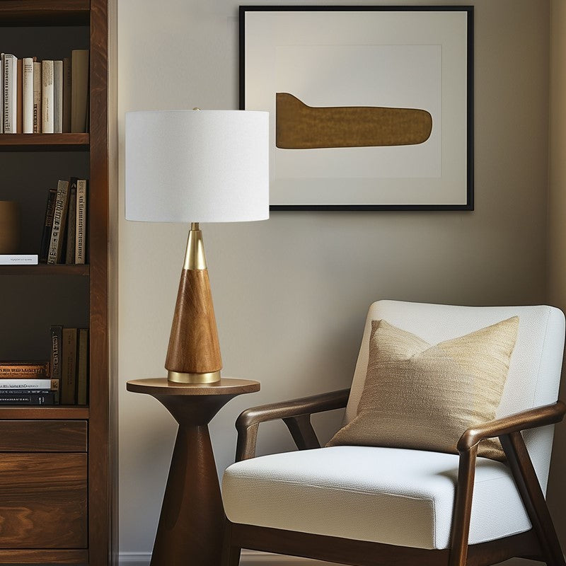 Triangular table lamp with a warm wooden cone base and white fabric shade on a round side table on Tampa Home & Garden Store