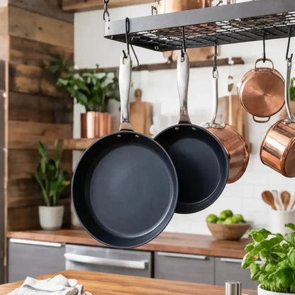 Alva Ceramic Nonstick Cookware Set two black frying pans with silver handles hung on a kitchen rack on Tampa Home & Garden Store