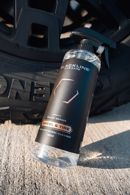 BLACKLINE WHEEL N' TIRE CLEANER bottle with black label near a wheel rim Blackline Car Care on Tampa Home & Garden Store