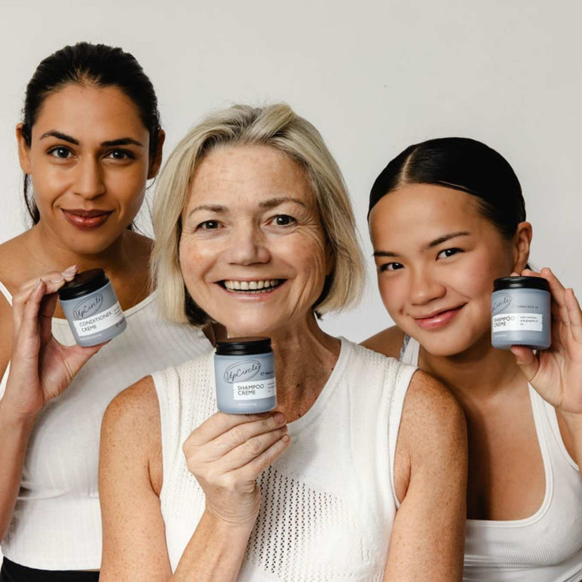 Shampoo + Conditioner Haircare Duo by UpCircle held by three smiling women with blue jars on Tampa Home & Garden Store