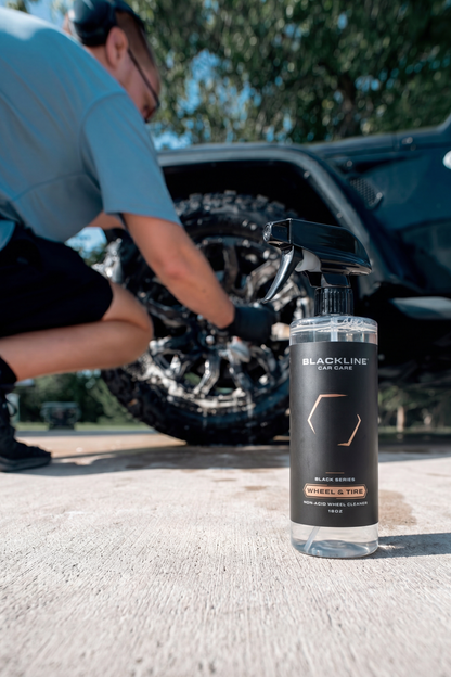 Blackline Wheel N' Tire Cleaner spray bottle in foreground with a car wheel in the background on Tampa Home & Garden Store