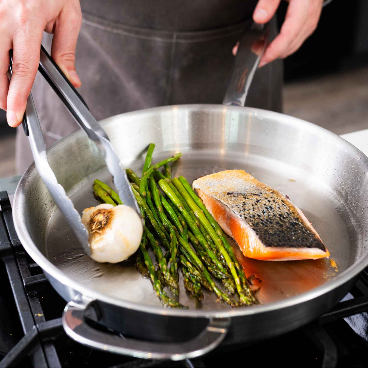 5-Ply Stainless Cookware Set, 14-Piece in stainless pan with asparagus and salmon on Tampa Home & Garden Store
