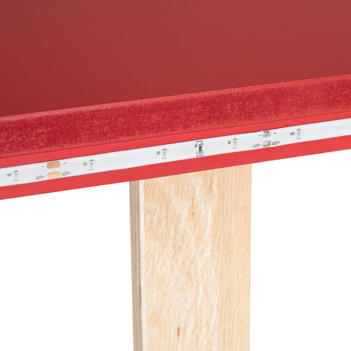 Red race car bed edge with LED strip along base and wood support leg on Tampa Home & Garden Store