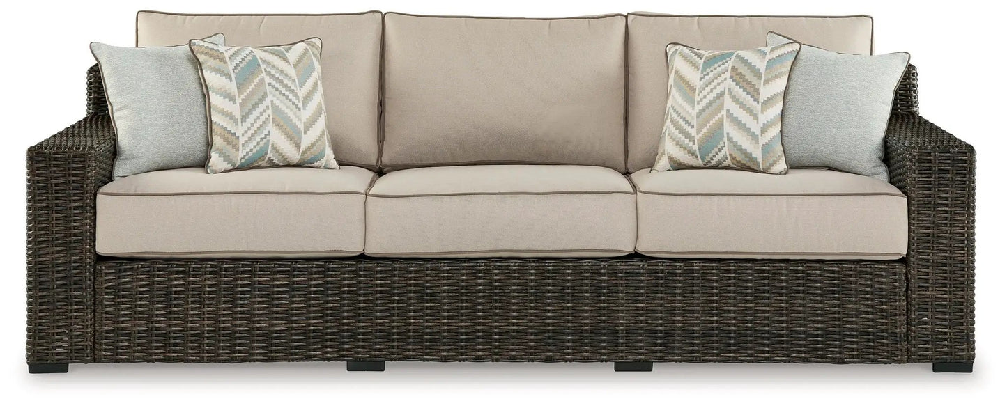 Coastline Bay sofa with beige cushions, dark wicker frame and blue chevron pillows on Tampa Home & Garden Store