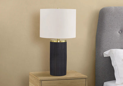 Table lamp with black ribbed base, brass ring, and white drum shade on Tampa Home & Garden Store