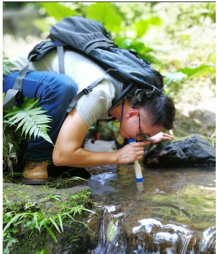 Outdoor Water Filter Camping Survival Tool, white and blue filter used by hiker at a stream on Tampa Home & Garden Store