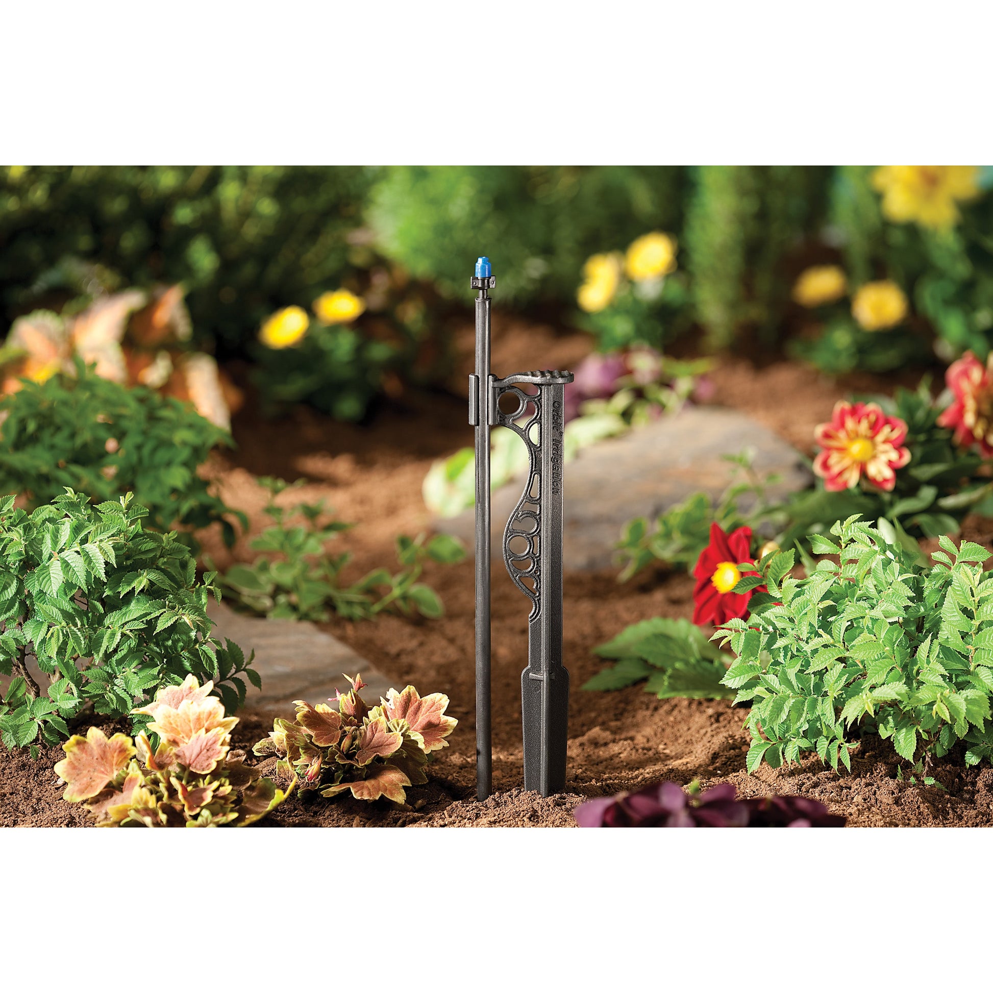 Drip stake Orbit Irrigation 1/4 in barb with 12 in extension riser, blue nozzle in garden bed on Tampa Home & Garden Store