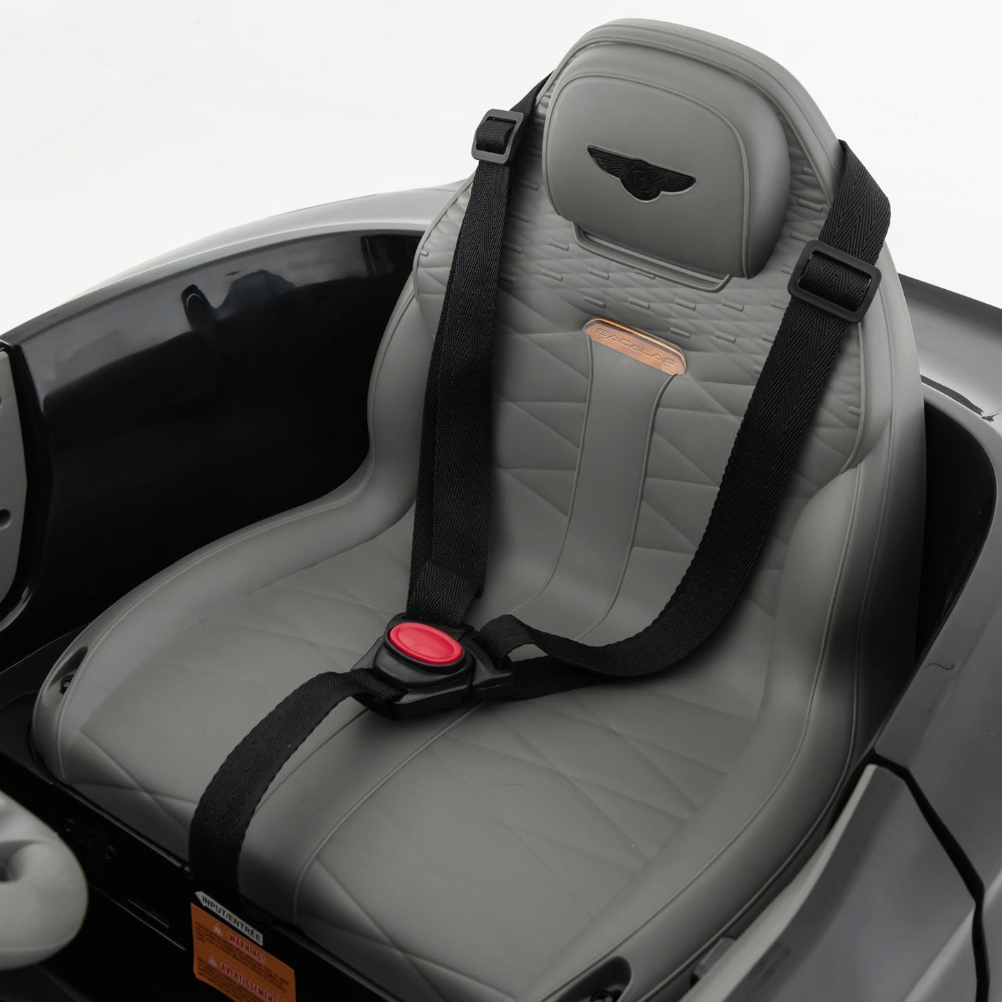 12V ride-on car interior gray seat with Bentley Bacalar headrest and black safety straps on Tampa Home & Garden Store