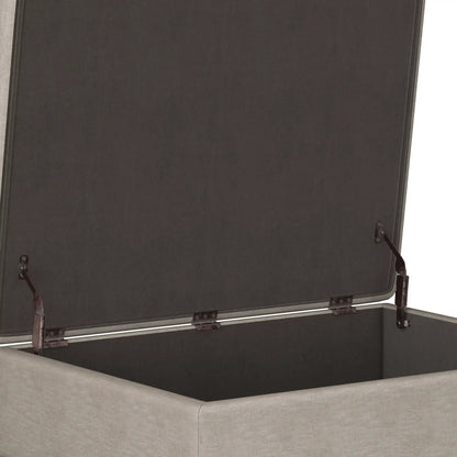 Owen upholstered rectangular storage ottoman in dark charcoal fabric with metal hardware on Tampa Home & Garden Store