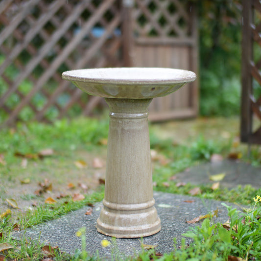 Ceramic bird bath on weathered pedestal in garden with rustic glaze on Tampa Home & Garden Store