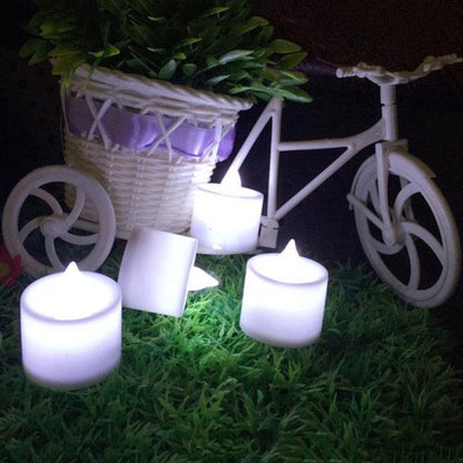 Stevvex 12pc LED tea lights battery-operated flameless candles flicker beside bicycle planter on Tampa Home & Garden Store