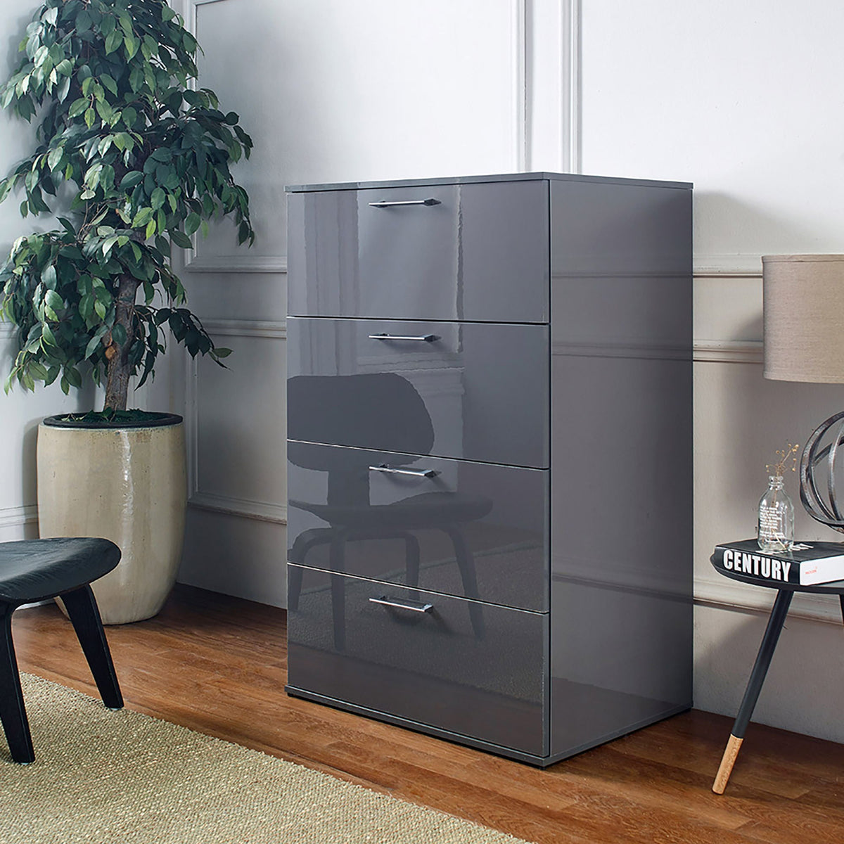 Glossy 4-drawer accent chest in dark gray with deep storage beside a leafy plant on Tampa Home & Garden Store