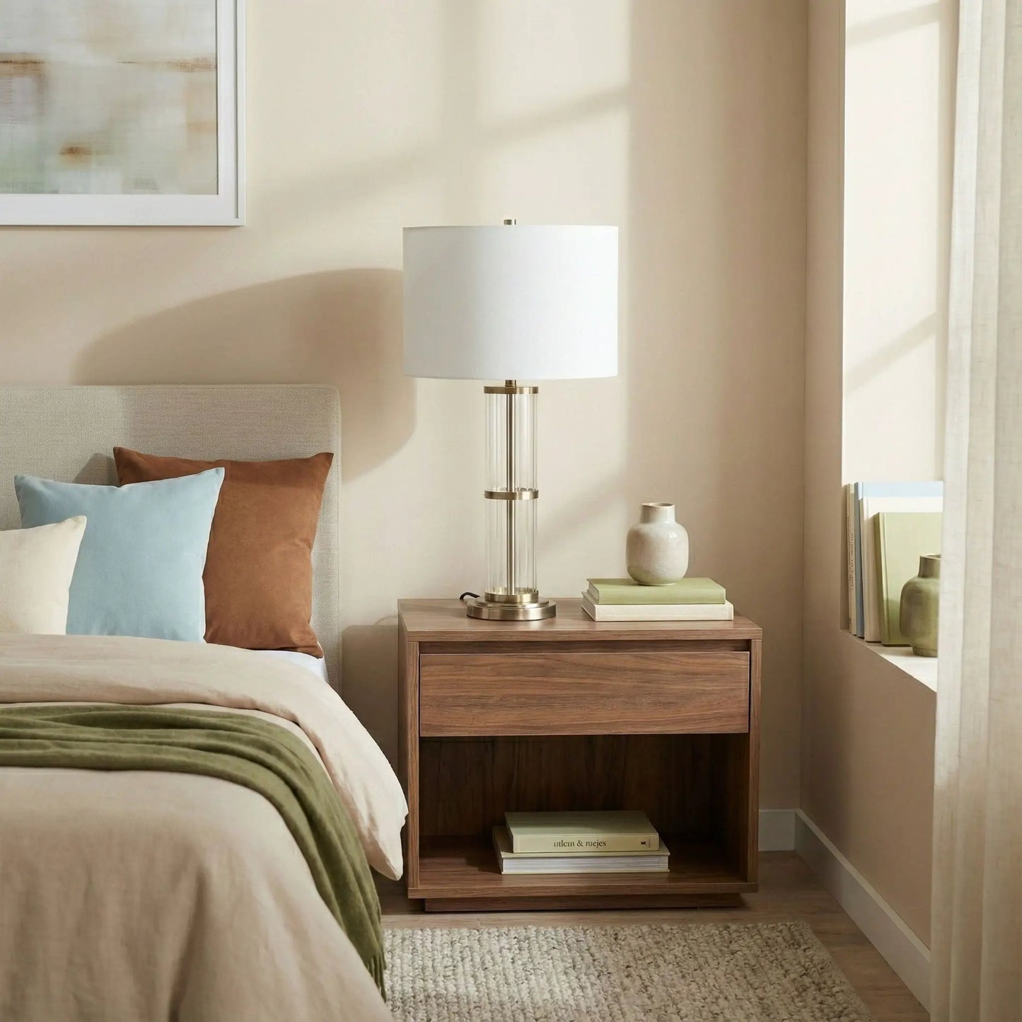 Echo table lamp with clear glass body and white drum shade on a nightstand on Tampa Home & Garden Store