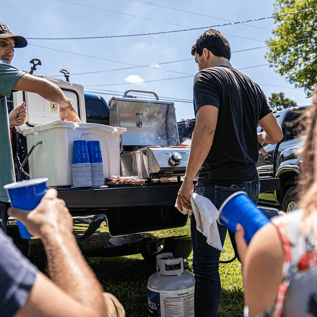 13742 Monument Grills stainless tabletop propane gas grill on a tailgate on Tampa Home & Garden Store