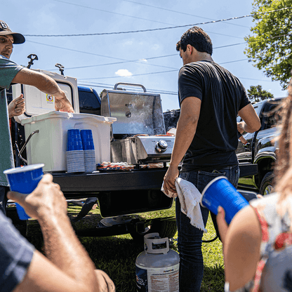 13742 Monument Grills stainless tabletop propane gas grill on a tailgate on Tampa Home & Garden Store