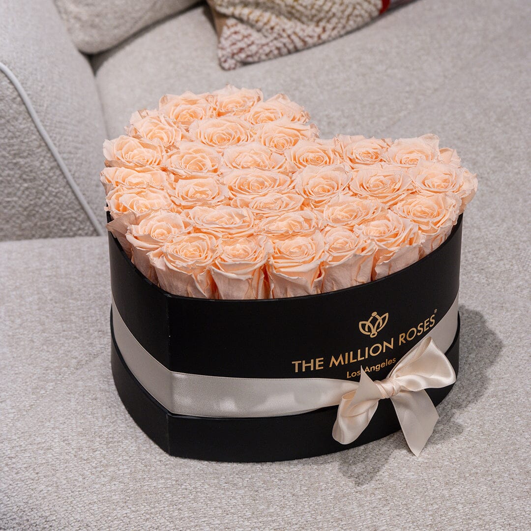 Peach eternity roses in a black round hatbox with white satin ribbon by The Million Roses on Tampa Home & Garden Store