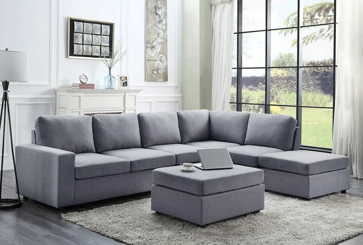 Cassia 7-seat reversible modular sectional sofa with ottoman in gray fabric, placed in a space on Tampa Home & Garden Store