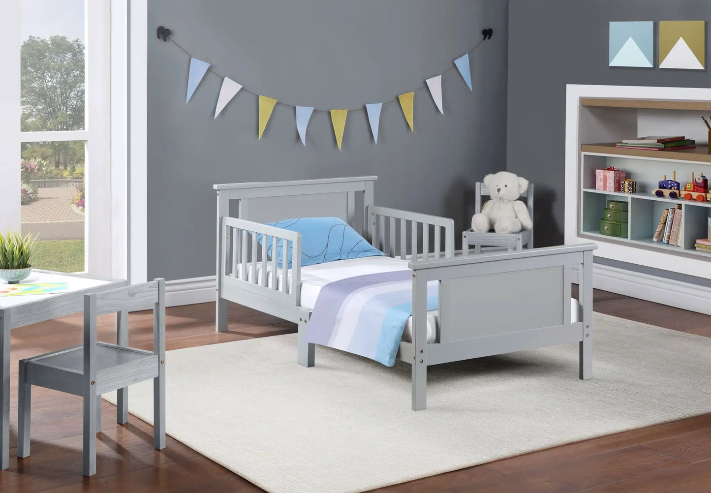 Connelly reversible panel toddler beds in gray wood with blue bedding, 2 shown on Tampa Home & Garden Store
