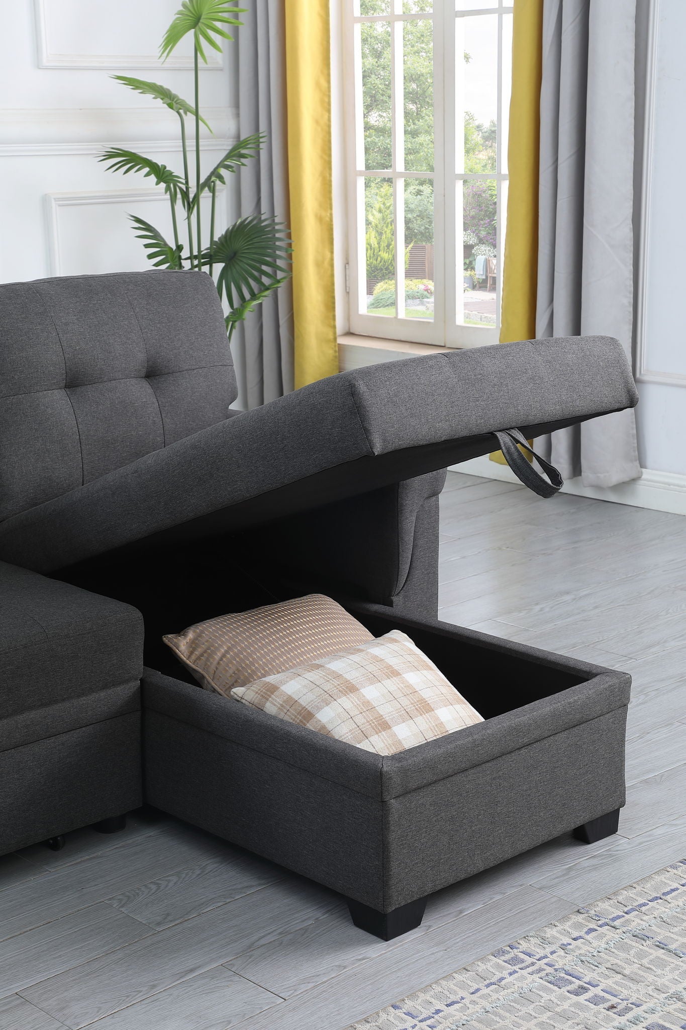 Lucca reversible sleeper sectional with storage chaise in dark gray fabric with lift-up ottoman on Tampa Home & Garden Store