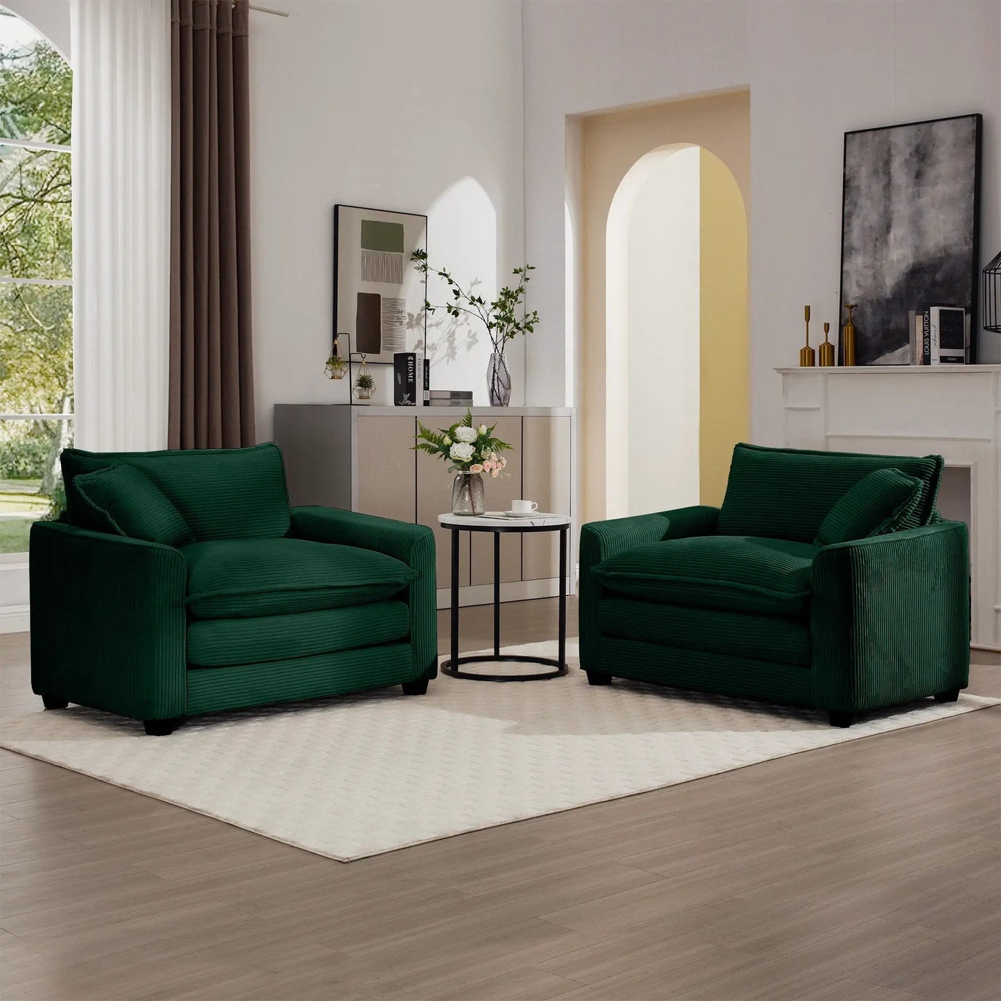 Pair of modern classic fabric arm chairs in deep green with plush pillows in living room on Tampa Home & Garden Store
