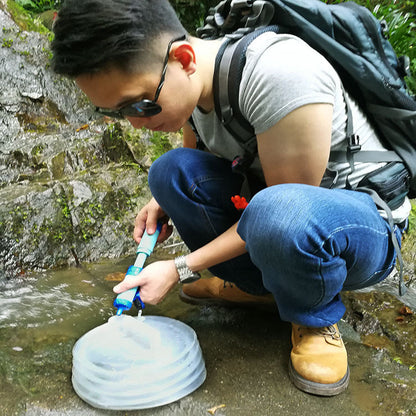 Outdoor Water Filter Camping Survival Tool with turquoise head purifying water into a bag on Tampa Home & Garden Store