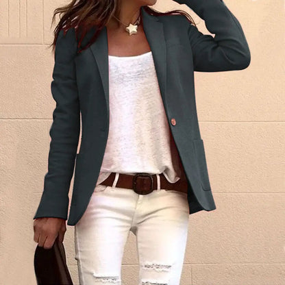 Candy-colored long-sleeved suit jacket in dark teal with white top and distressed jeans on Tampa Home & Garden Store