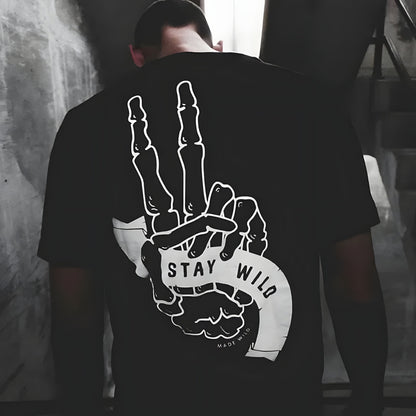 Black cotton T-shirt by BikerZoneZ with white bone hand showing a two-finger Stay Wild gesture on Tampa Home & Garden Store