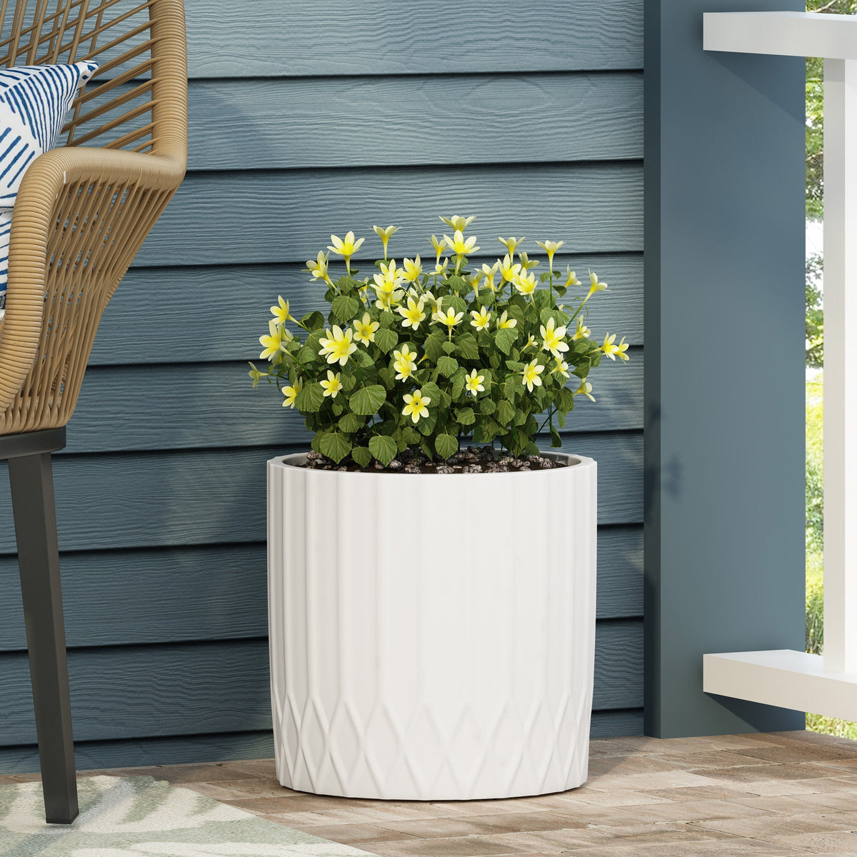 HouseOfZazla MGO planter, white ceramic ribbed planter with yellow flowers on a blue wall on Tampa Home & Garden Store