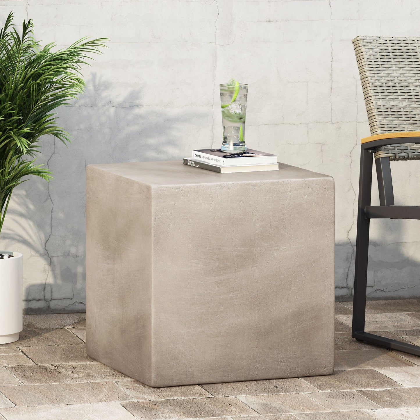 Outdoor Indoor Square Lightweight Side Table, beige concrete look, with books and a glass on Tampa Home & Garden Store