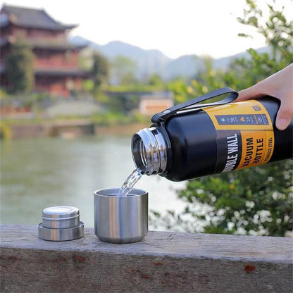 Stevvex 1500ml stainless thermos water bottle pouring into metal cup black with silver cap on Tampa Home & Garden Store