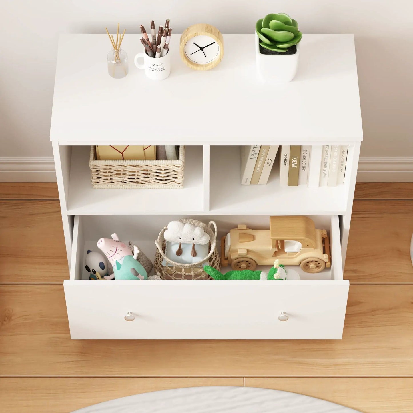 White toy storage organizer with drawer and low bookshelf; plant and baskets with books on Tampa Home & Garden Store