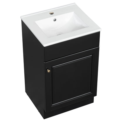 Bathroom vanity with white sink atop a black cabinet featuring brass knobs on Tampa Home & Garden Store
