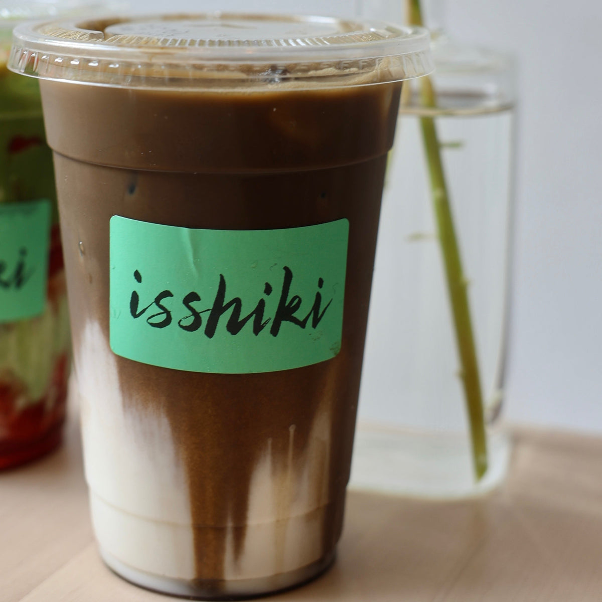 Hojicha Roasted Green Tea Powder premium matcha iced drink in a to-go cup with a green isshiki label on Tampa Home & Garden Store
